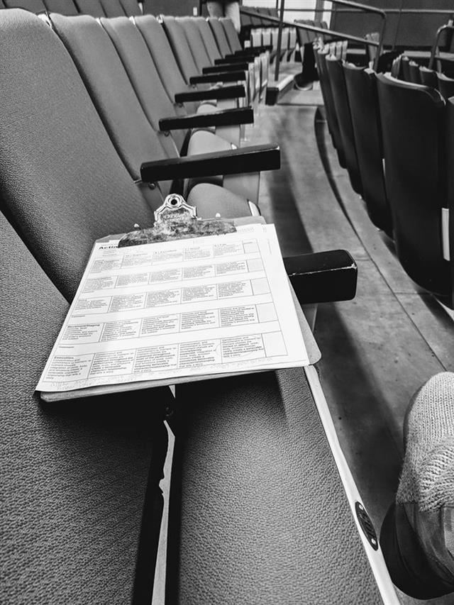 Grading rubric and clipboard on auditorium seats Grading rubric and clipboard on auditorium seats