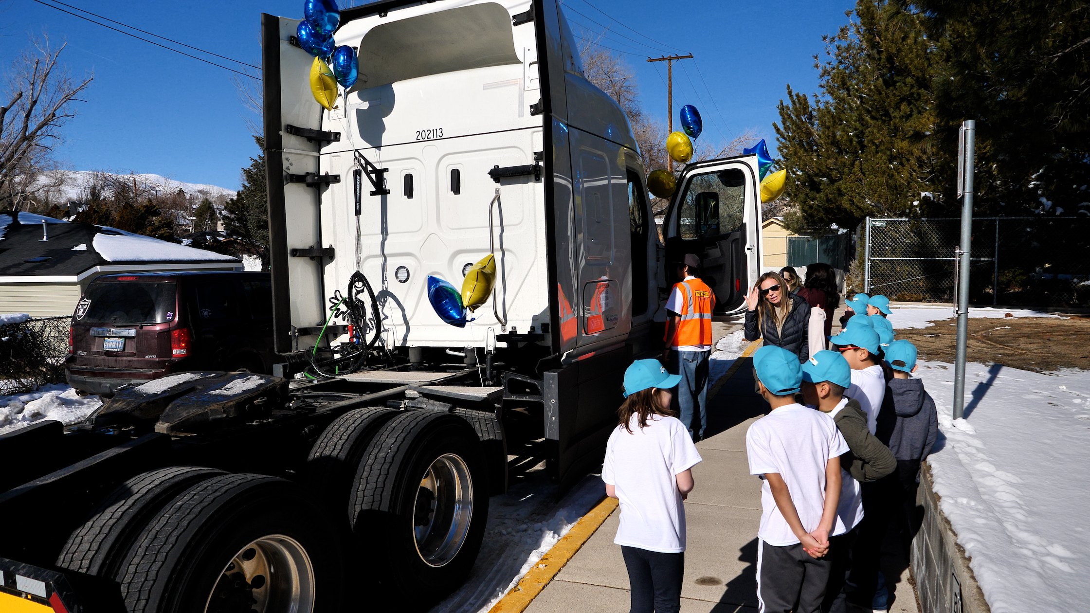  kids look at a semi tractor
