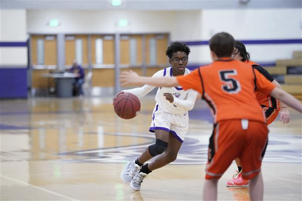 Spanish springs player dribbling down the court