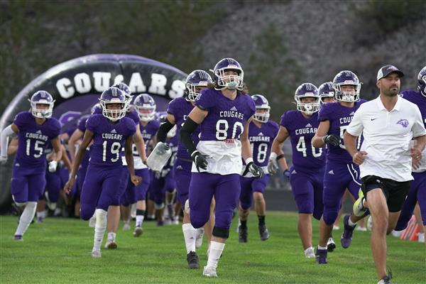 Spanish Springs Football team running in a field