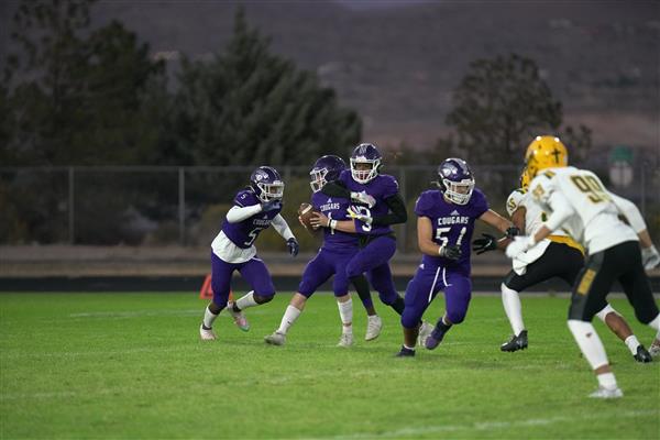 Spanish springs handing the football off to the running back