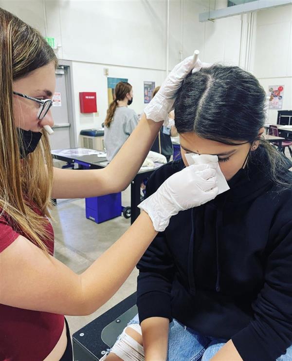 Two people in sports med doing a lab