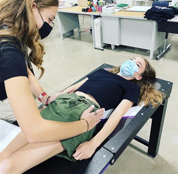 Two students in sports med doing hip alignment